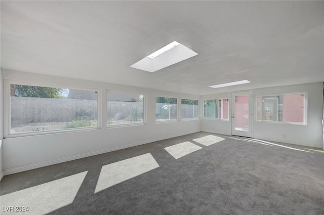 unfurnished sunroom featuring a skylight