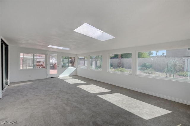 unfurnished sunroom with a skylight