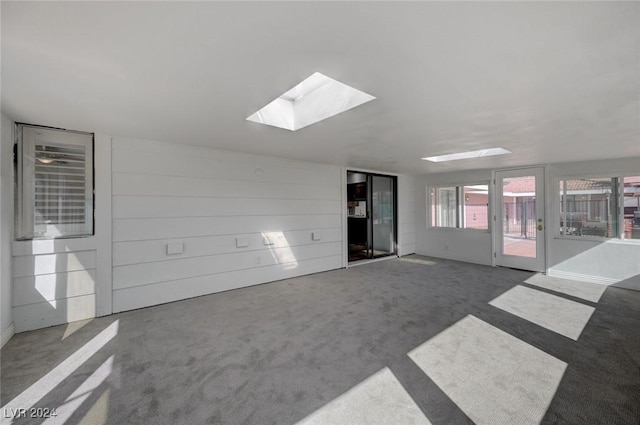 spare room featuring a skylight and carpet