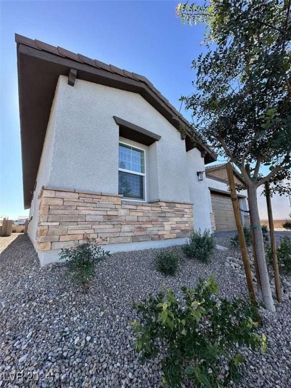 view of side of property featuring a garage