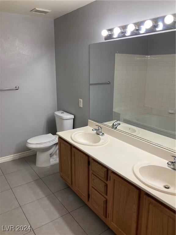 bathroom featuring tile patterned flooring, vanity, and toilet