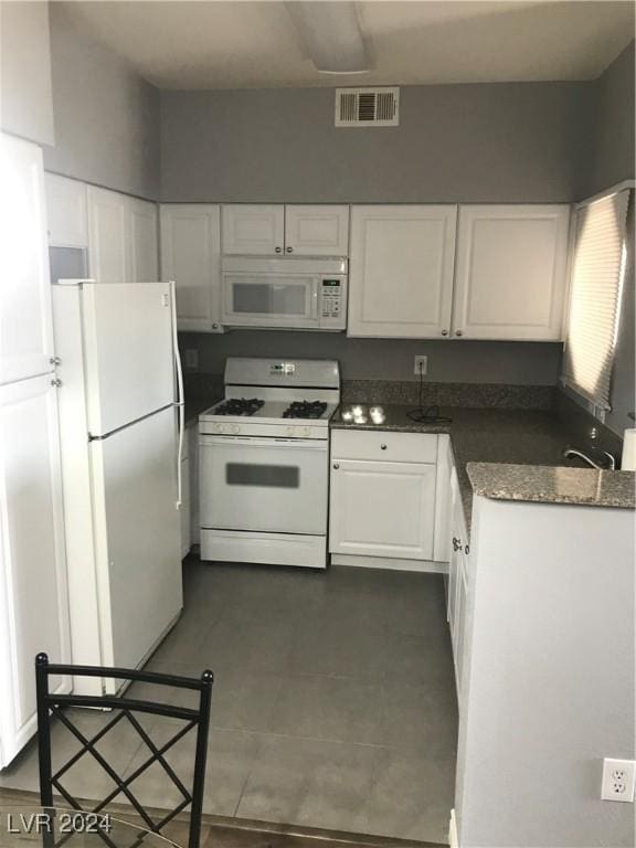 kitchen with white cabinets and white appliances