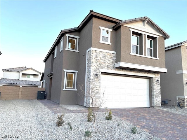 exterior space with a garage and central air condition unit