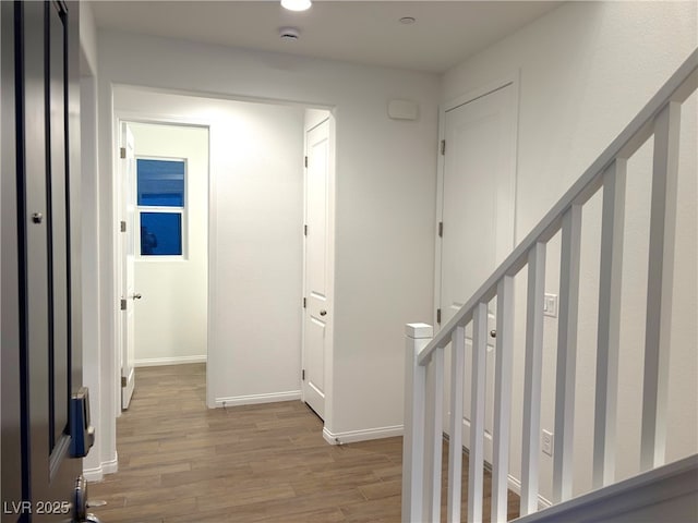 hallway with hardwood / wood-style floors