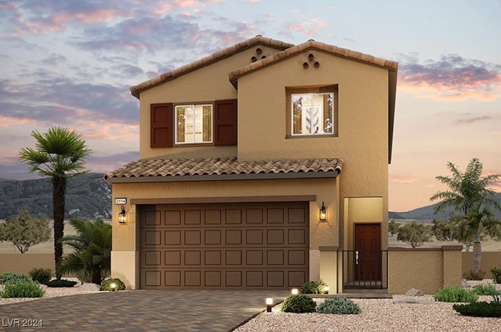 mediterranean / spanish house featuring a mountain view and a garage