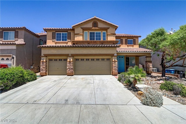 mediterranean / spanish house with a garage