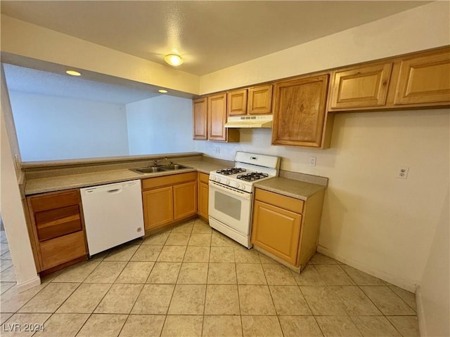 kitchen featuring light tile patterned floors, white appliances, and sink