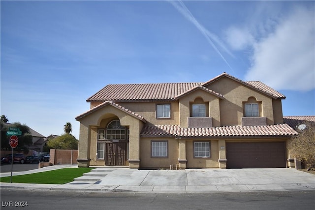 mediterranean / spanish-style house featuring a garage