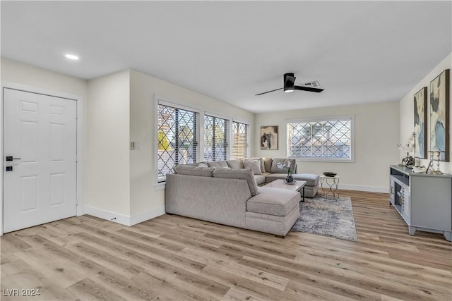 living room with ceiling fan and light hardwood / wood-style floors