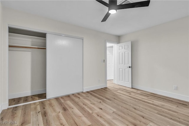 unfurnished bedroom with ceiling fan, a closet, and light hardwood / wood-style floors