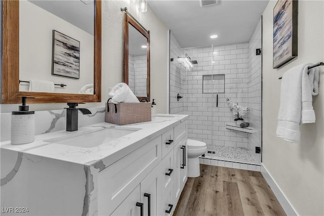 bathroom with toilet, vanity, an enclosed shower, and hardwood / wood-style flooring