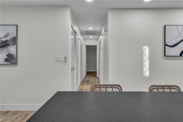 hallway with light hardwood / wood-style flooring