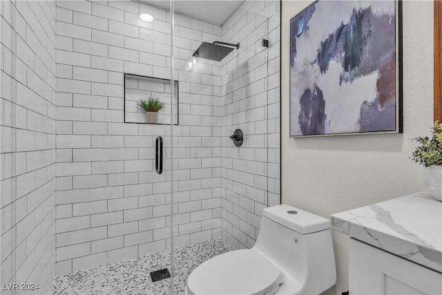 bathroom featuring an enclosed shower, vanity, and toilet