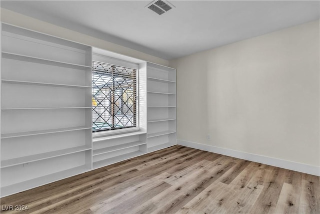 unfurnished room with light hardwood / wood-style flooring