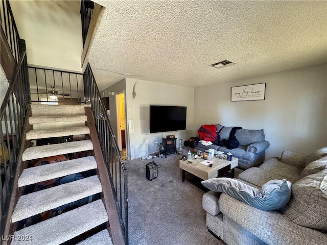 living room featuring a textured ceiling and carpet floors