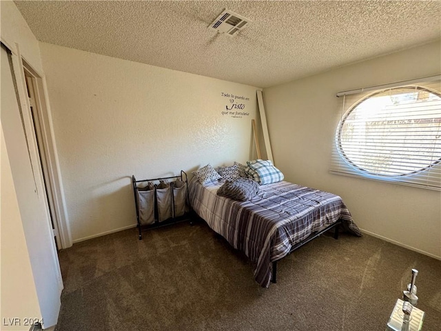 carpeted bedroom with a textured ceiling