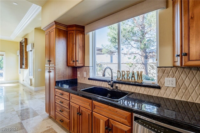 kitchen with backsplash, crown molding, dishwasher, and sink