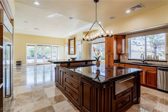 kitchen with backsplash, plenty of natural light, a kitchen island, and stainless steel dishwasher