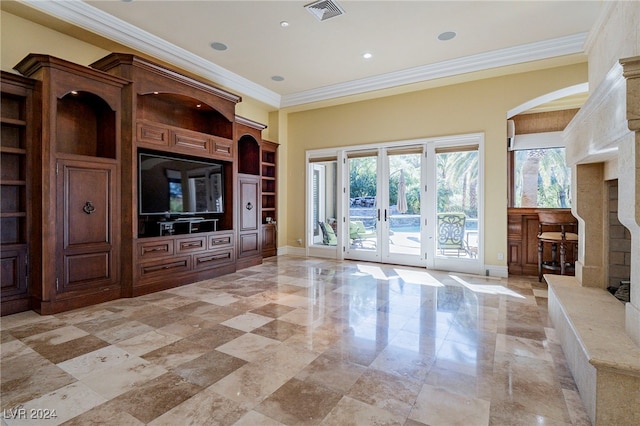 unfurnished living room with built in shelves, crown molding, and french doors