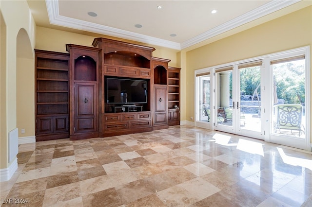 unfurnished living room featuring built in shelves, ornamental molding, and french doors