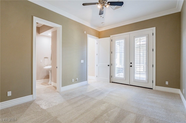 empty room featuring ceiling fan, french doors, light colored carpet, and ornamental molding