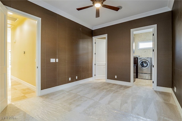 unfurnished bedroom featuring ceiling fan, washing machine and dryer, ornamental molding, connected bathroom, and light colored carpet