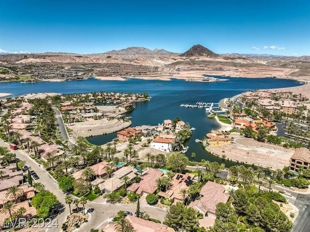 drone / aerial view featuring a water and mountain view