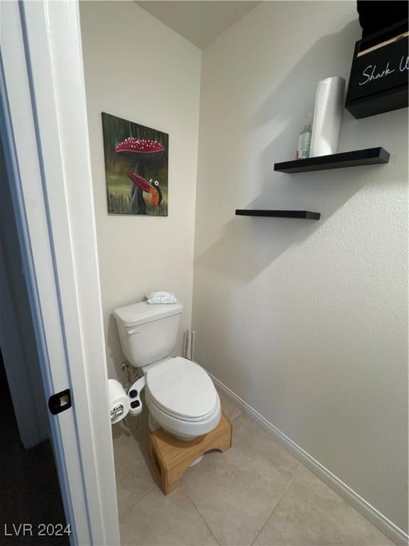 bathroom featuring tile patterned floors and toilet