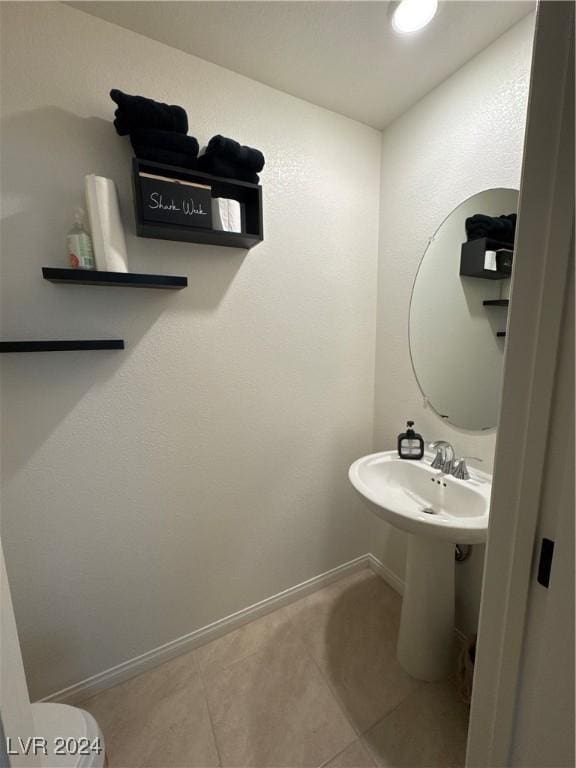 bathroom with toilet and tile patterned flooring