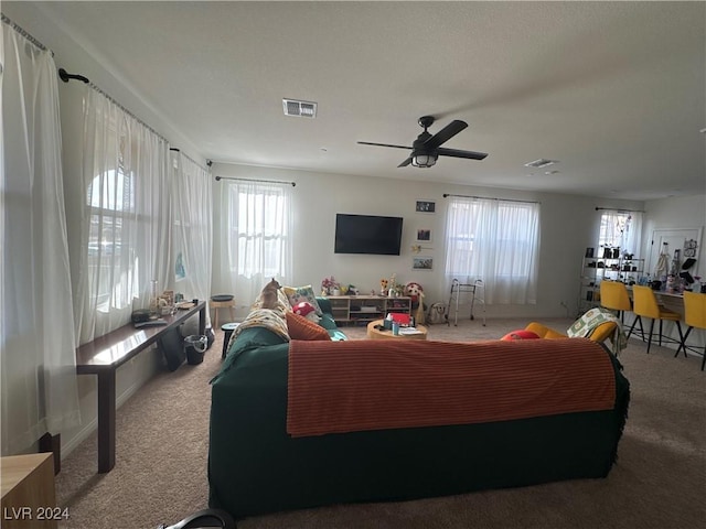 living room with ceiling fan and carpet floors