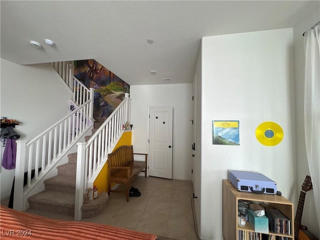 stairway with tile patterned flooring