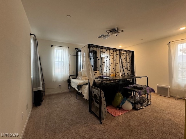 bedroom featuring multiple windows and carpet flooring