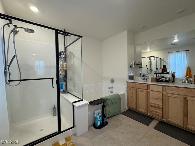 bathroom featuring tile patterned floors, vanity, and shower with separate bathtub