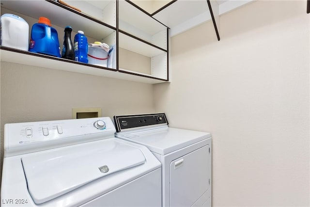 clothes washing area featuring separate washer and dryer