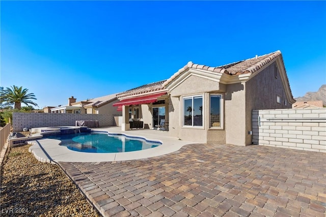 view of pool featuring an in ground hot tub and a patio