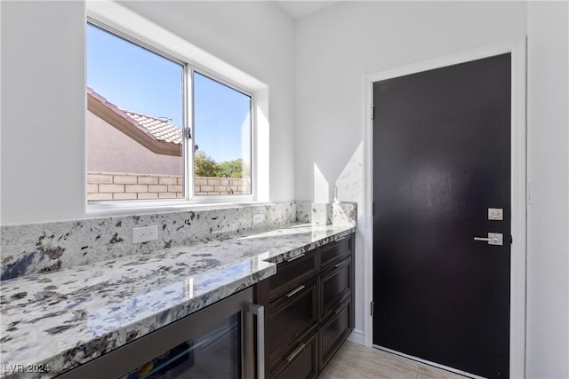 bathroom with tile patterned floors, vanity, and wine cooler