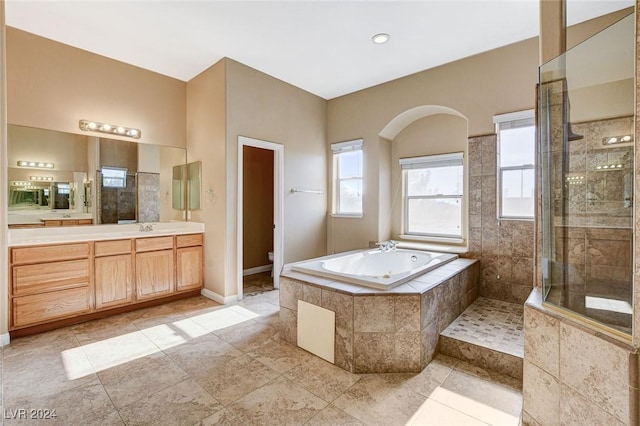 full bathroom with vanity, toilet, and plus walk in shower