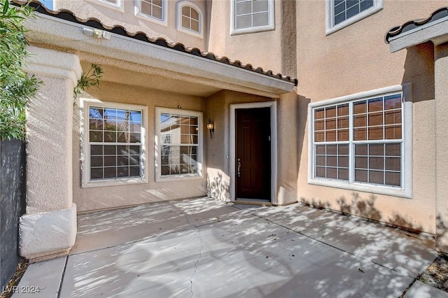 property entrance featuring a patio area