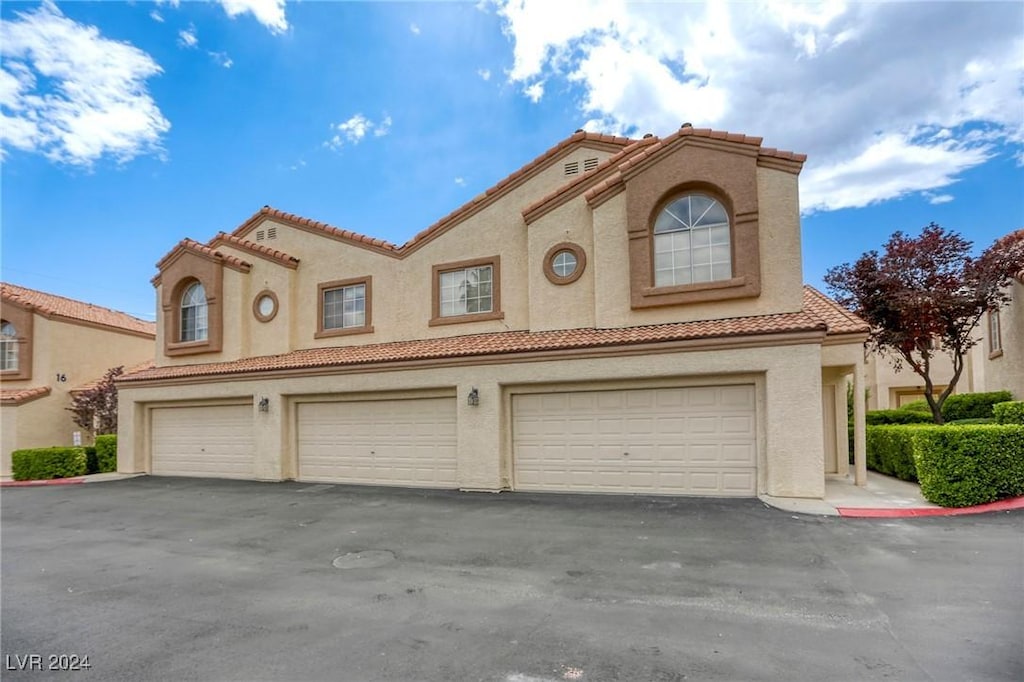 mediterranean / spanish-style home featuring a garage