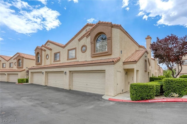 mediterranean / spanish house featuring a garage