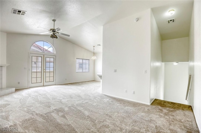 unfurnished living room with carpet, a textured ceiling, ceiling fan, and lofted ceiling