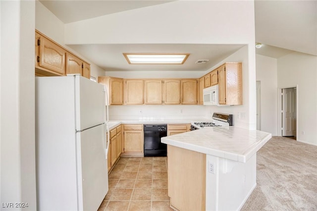 kitchen featuring kitchen peninsula, light colored carpet, vaulted ceiling, white appliances, and light brown cabinetry