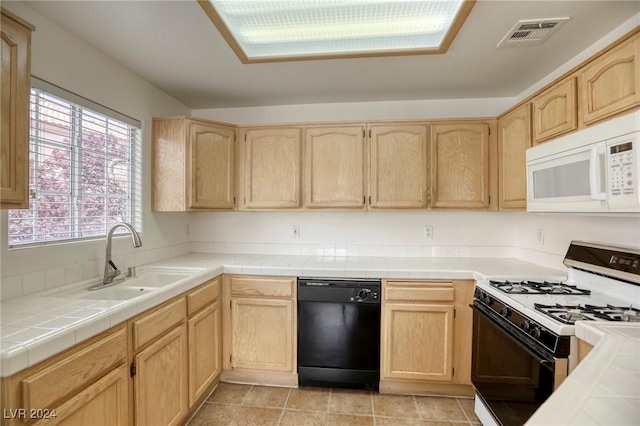 kitchen featuring tile counters, white appliances, and light brown cabinets