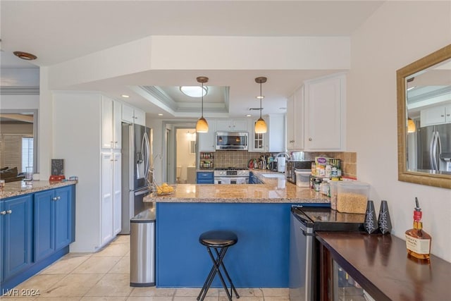 kitchen featuring blue cabinets, kitchen peninsula, decorative light fixtures, white cabinets, and appliances with stainless steel finishes