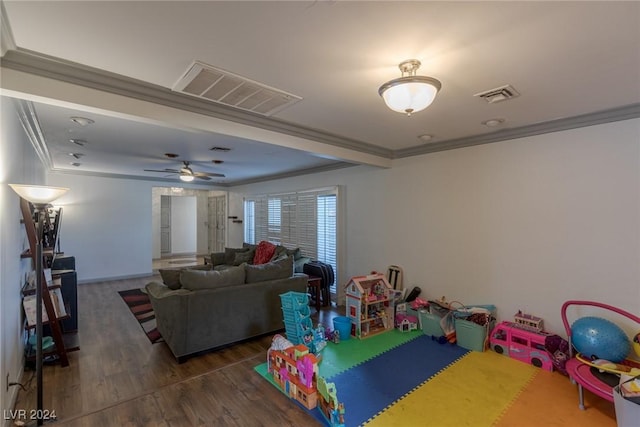 game room with dark hardwood / wood-style flooring, ceiling fan, and crown molding