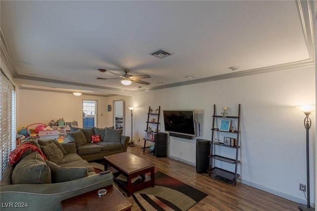 living room with a tray ceiling, crown molding, ceiling fan, and wood-type flooring