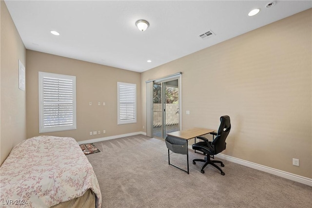 bedroom with light carpet and access to outside