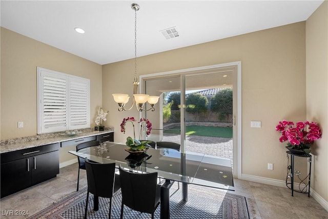 tiled dining space featuring a notable chandelier