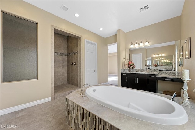 bathroom with shower with separate bathtub, vanity, and tile patterned floors