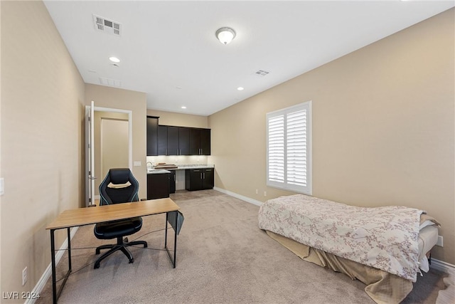 bedroom featuring light colored carpet